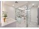 Elegant main bathroom with marble accents, a soaking tub, and a spacious glass-enclosed shower at 5259 E Karen Dr, Scottsdale, AZ 85254
