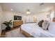 Comfortable main bedroom featuring hardwood floors, dresser, and a flat screen TV for modern living at 5259 E Karen Dr, Scottsdale, AZ 85254