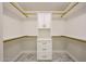 Organized walk-in closet with custom shelving, drawers, and ample storage space at 5259 E Karen Dr, Scottsdale, AZ 85254