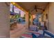 Covered outdoor patio with a ceiling fan, colorful rug, and comfortable seating, perfect for relaxing outdoors at 5930 E Fountain St, Mesa, AZ 85205