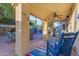 Covered back patio featuring a ceiling fan, comfortable seating, and views of the pool and backyard at 5930 E Fountain St, Mesa, AZ 85205