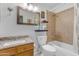 Well-lit bathroom with a granite-topped vanity, a toilet, and a tiled shower/tub combination at 5930 E Fountain St, Mesa, AZ 85205