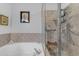 Inviting bathroom featuring a soaking tub with tile surround, a glass-enclosed shower, and custom fixtures at 5930 E Fountain St, Mesa, AZ 85205