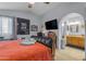 A cozy bedroom featuring a vaulted ceiling, and a connected bathroom for added convenience at 5930 E Fountain St, Mesa, AZ 85205