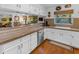 Bright kitchen featuring white cabinetry, granite countertops, and stainless steel appliances at 5930 E Fountain St, Mesa, AZ 85205