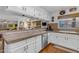 Spacious kitchen featuring white cabinets, stainless steel appliances, granite countertops, and hardwood floors at 5930 E Fountain St, Mesa, AZ 85205