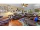 Spacious living room with hardwood floors, comfortable leather seating, and a ceiling fan at 5930 E Fountain St, Mesa, AZ 85205