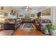 Spacious living room with hardwood floors, comfortable leather seating, and a ceiling fan at 5930 E Fountain St, Mesa, AZ 85205