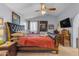 Comfortable main bedroom with a ceiling fan, soft carpet, and TV at 5930 E Fountain St, Mesa, AZ 85205