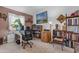 Inviting home office with ample desk space, bookshelves, and a comfortable office chair at 5930 E Fountain St, Mesa, AZ 85205