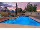 Private pool with elegant landscaping, comfortable patio set, and an umbrella, perfect for enjoying the outdoors at 5930 E Fountain St, Mesa, AZ 85205
