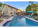Inviting backyard pool with blue tile border, surrounded by a spacious deck and lush greenery at 5930 E Fountain St, Mesa, AZ 85205