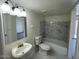 Bathroom with vanity, mirror, tub/shower combo, and gray and white marbled tile surround at 6565 N 19Th Ave # 38, Phoenix, AZ 85015