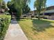Well-maintained community green space with manicured lawns and walking path at 6565 N 19Th Ave # 38, Phoenix, AZ 85015