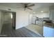 Bright kitchen with white cabinets and updated appliances, adjacent to flexible living space at 6565 N 19Th Ave # 38, Phoenix, AZ 85015