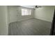 Bright living room with updated floors, complemented by a large window and neutral wall paint at 6565 N 19Th Ave # 38, Phoenix, AZ 85015