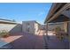 Backyard with a shed, patio, and desert landscaping at 7132 W Vermont Ave, Glendale, AZ 85303