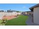 Spacious backyard featuring green grass, minimalist landscaping, and privacy wall at 7132 W Vermont Ave, Glendale, AZ 85303