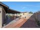 Backyard with a covered patio, shed, and desert landscaping at 7132 W Vermont Ave, Glendale, AZ 85303