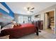 Well-lit bedroom with ceiling fan, modern lighting and attached bathroom at 7132 W Vermont Ave, Glendale, AZ 85303