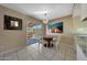 Dining area featuring chandelier, tile floors, sliding glass doors to backyard, and backyard views at 7132 W Vermont Ave, Glendale, AZ 85303