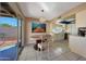 Dining area offering tile floors, chandelier, view of kitchen, and sliding glass door to backyard at 7132 W Vermont Ave, Glendale, AZ 85303