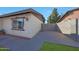 The home's exterior has a convenient concrete area, and a section of green lawn, creating a neat and tidy space at 7132 W Vermont Ave, Glendale, AZ 85303