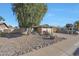 Inviting single-story home with desert landscaping including river rock, cacti, and flowering plants at 7132 W Vermont Ave, Glendale, AZ 85303
