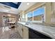 Sunlit kitchen boasts marble countertops, stainless steel appliances, and an adjacent dining area with backyard view at 7132 W Vermont Ave, Glendale, AZ 85303