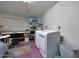 Functional laundry room featuring modern washer and dryer, shelving, and ample storage space at 7132 W Vermont Ave, Glendale, AZ 85303