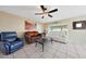 Cozy living room offering tile floors, ceiling fan, large window, and comfortable seating at 7132 W Vermont Ave, Glendale, AZ 85303