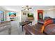 Comfortable living room with leather sofas, ceiling fan, tile floor, and dining area, offering a relaxing and inviting space at 7132 W Vermont Ave, Glendale, AZ 85303