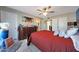 Cozy main bedroom with decorative dresser, ceiling fan, ensuite access, and tiled flooring at 7132 W Vermont Ave, Glendale, AZ 85303
