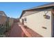 Brick paved side yard with low maintenance desert landscaping, leading to backyard at 7132 W Vermont Ave, Glendale, AZ 85303