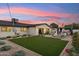 Scenic backyard with a plush lawn, patio area, lush landscaping, and an inviting pergola at 7432 E Holly St, Scottsdale, AZ 85257