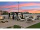 Relaxing backyard with an inviting pergola, comfortable seating, and beautiful landscaping at dusk at 7432 E Holly St, Scottsdale, AZ 85257