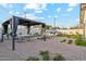 Backyard featuring a covered patio, comfortable seating, and lush landscaping, perfect for outdoor entertaining and relaxation at 7432 E Holly St, Scottsdale, AZ 85257