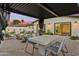 Covered patio seating area perfect for outdoor dining and entertaining, surrounded by lush landscaping at 7432 E Holly St, Scottsdale, AZ 85257