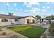 Well-maintained backyard with artificial grass, covered patio, and outdoor seating area, offering a perfect spot for relaxation at 7432 E Holly St, Scottsdale, AZ 85257