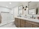 Bright bathroom featuring double sinks, modern fixtures, and a walk-in shower at 7432 E Holly St, Scottsdale, AZ 85257