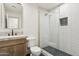 Modern bathroom with stylish vanity, toilet, and glass shower with a recessed shelf at 7432 E Holly St, Scottsdale, AZ 85257