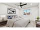 Well-lit bedroom with neutral tones, a ceiling fan, a window view, and a decorative painting at 7432 E Holly St, Scottsdale, AZ 85257