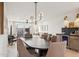 Elegant dining room with a large table, stylish chandelier, and seamless flow to the living area at 7432 E Holly St, Scottsdale, AZ 85257