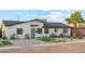 Charming single-story home featuring manicured landscaping, desert plants, and a brick driveway, offering great curb appeal at 7432 E Holly St, Scottsdale, AZ 85257