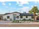 Charming single-story home featuring manicured landscaping, desert plants, and a brick driveway, offering great curb appeal at 7432 E Holly St, Scottsdale, AZ 85257