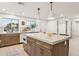 Spacious kitchen island with marble countertop, integrated oven, and plenty of cabinet space for storage and food preparation at 7432 E Holly St, Scottsdale, AZ 85257