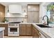 Bright kitchen features marble countertops, modern appliances, wooden cabinets, and a stylish faucet at 7432 E Holly St, Scottsdale, AZ 85257
