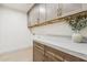 Well-appointed laundry room featuring custom cabinets, stone countertops, and ample counter space for folding and sorting at 7432 E Holly St, Scottsdale, AZ 85257