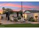 Charming backyard pergola with stylish seating, ambient lighting, and landscaped surroundings at sunset at 7432 E Holly St, Scottsdale, AZ 85257