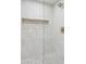 Bright shower with mosaic tile detail in recessed shelf and a glass door at 7432 E Holly St, Scottsdale, AZ 85257